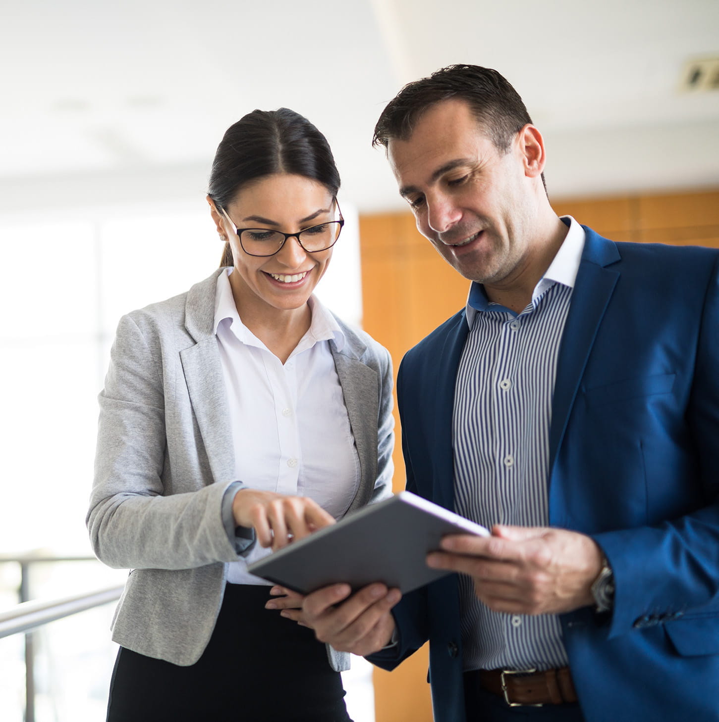 Two business people reading a tablet