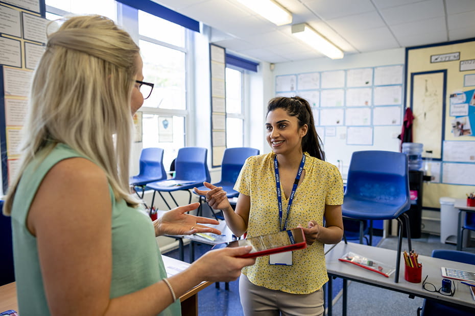 Teachers talking in a classroom